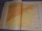 an open book with a map on it on a table