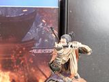 a figurine of a man holding a sword in front of a book
