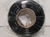a close up of a roll of black wire wrapped in plastic