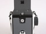 a black and white photo of a camera on a white surface