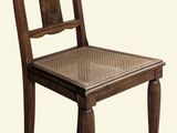 a wooden chair with a wicker seat on a white background