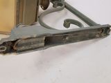 an old metal door handle with a latch on it