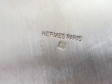 a close up of a silver plate with a logo on it