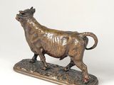 bronze statue of a bull on a wooden base on a white background