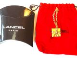 a red bag with a gold chain and a red bag with a gold chain