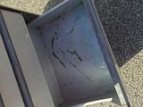 a broken microwave oven sitting on the ground
