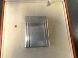 a silver cigarette case in a red box on a table