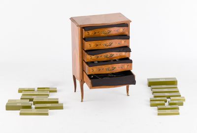 a small chest of drawers with a lot of drawers in it