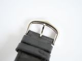 a close up of a black watch strap on a white surface