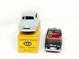 two toy cars sitting on top of a box next to each other