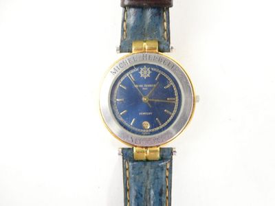 an image of a close up of a wrist watch on a white surface