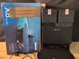 a box with a game controller and a charger on a table