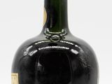 an image of a bottle of liquor sitting on a white surface