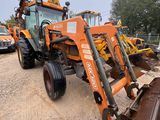 a tractor that is parked in the dirt