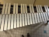 a person standing next to a piano on the floor