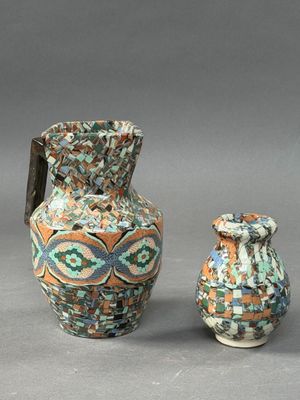 two vases and a small vase sitting next to each other on a gray surface