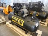 two air compressors sitting on pallets in a warehouse