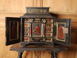 an old wooden cabinet with a door open on a table