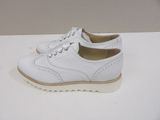 they are white shoes on a white table with a white background