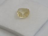 a yellow diamond sits on top of a white cloth