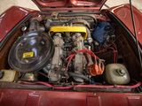 a small engine in the trunk of a red car