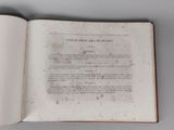 an open book with a page in it on a table