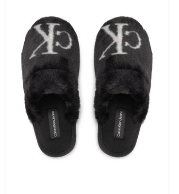 black slippers with white letters and a monogram on the side