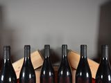 several bottles of wine are lined up in a row on a table