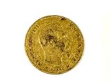 a close up of a gold coin on a white surface