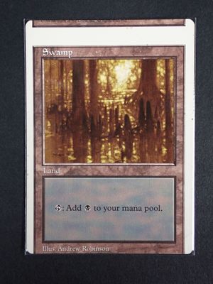 a close up of a card with a picture of a swamp in the background