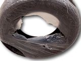 a donut wrapped in plastic and sitting on a white surface