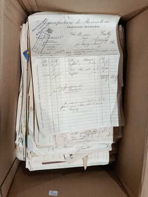 a cardboard box with a lot of papers inside of it