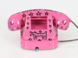 a pink telephone with hearts and stars on it