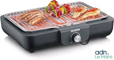 an image of a grill with meat and vegetables cooking on it