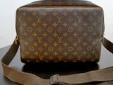 a brown and tan louis vuitton bag sitting on a table