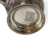 silver plated teapot with handle and lid on a white surface