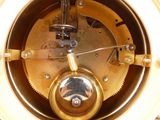 a close up of a clock that is on a table