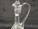 a clear glass decanter on a black background