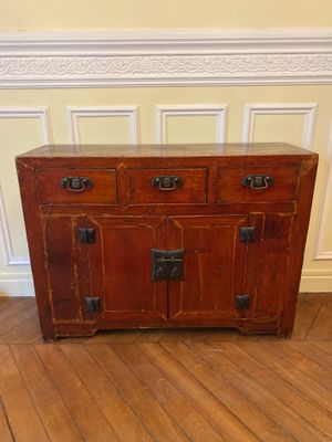 a small wooden cabinet on a hard wood floor