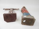 pair of old hammers and a wooden block on a white surface