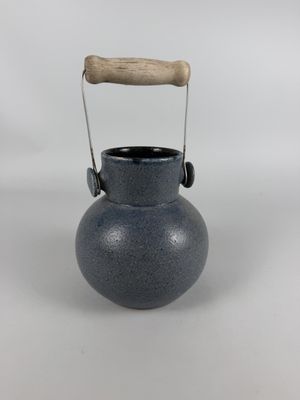 an image of a blue vase with a wooden handle on a white background