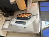 a box of food sitting on a table next to a laptop computer