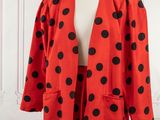 a red and black polka dot jacket and skirt suit on a mannequin mannequin mannequin mannequin mannequin mannequin manne