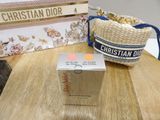 a box of christian dior perfume next to a purse on a table