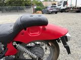a red and black motorcycle parked in a parking lot