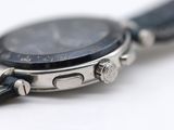 a close up of a watch on a white surface
