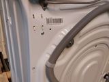 a white dishwasher with a hose attached to it