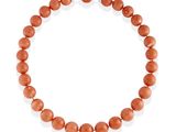 a coral beaded necklace on a white background