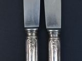 two knives that are sitting next to each other on a table