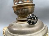 a close up of a lamp with a metal base